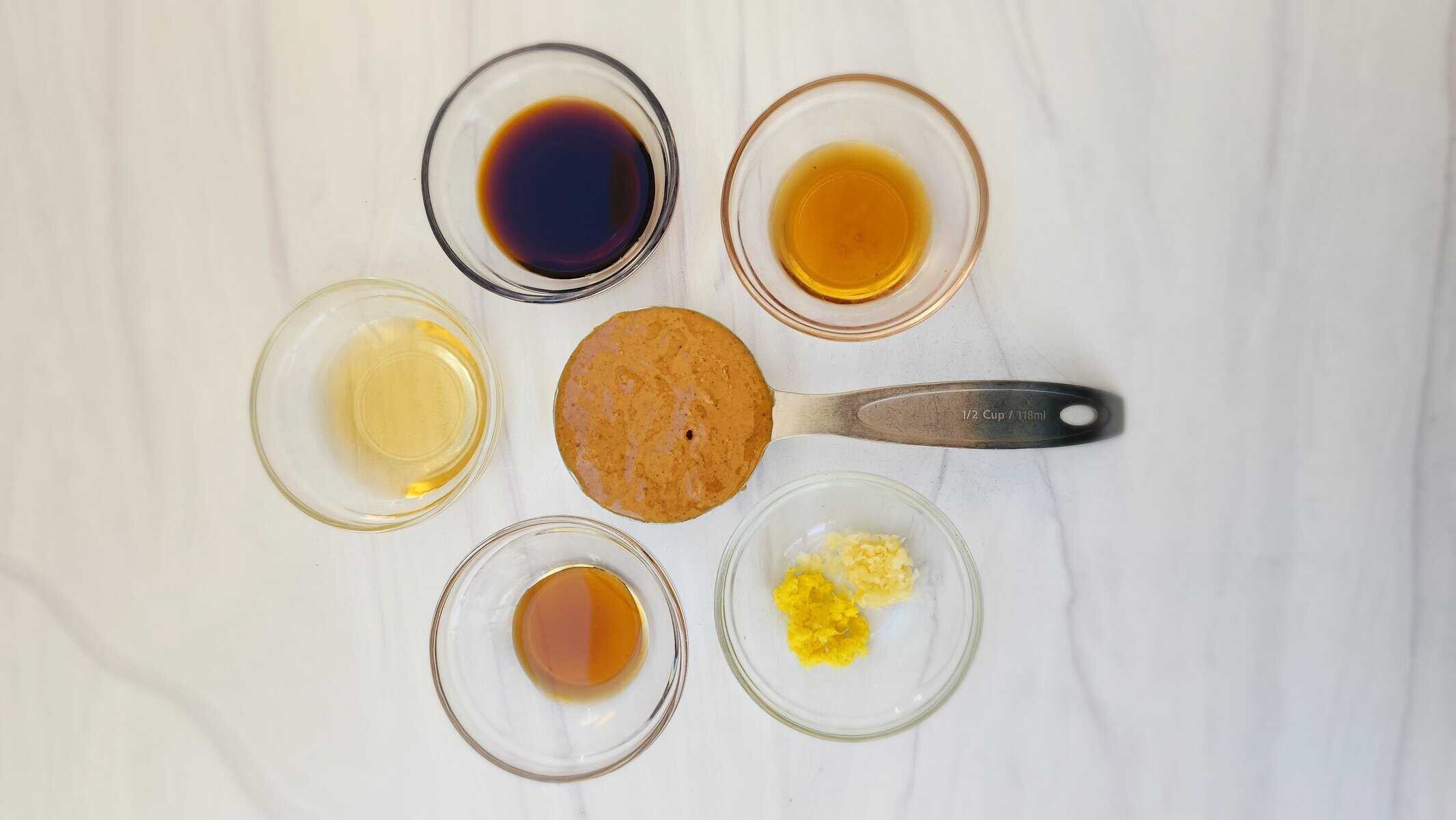 ingredients for easy peanut sauce: rice vinegar, soy sauce, peanut butter, sesame oil, maple syrup, grated ginger