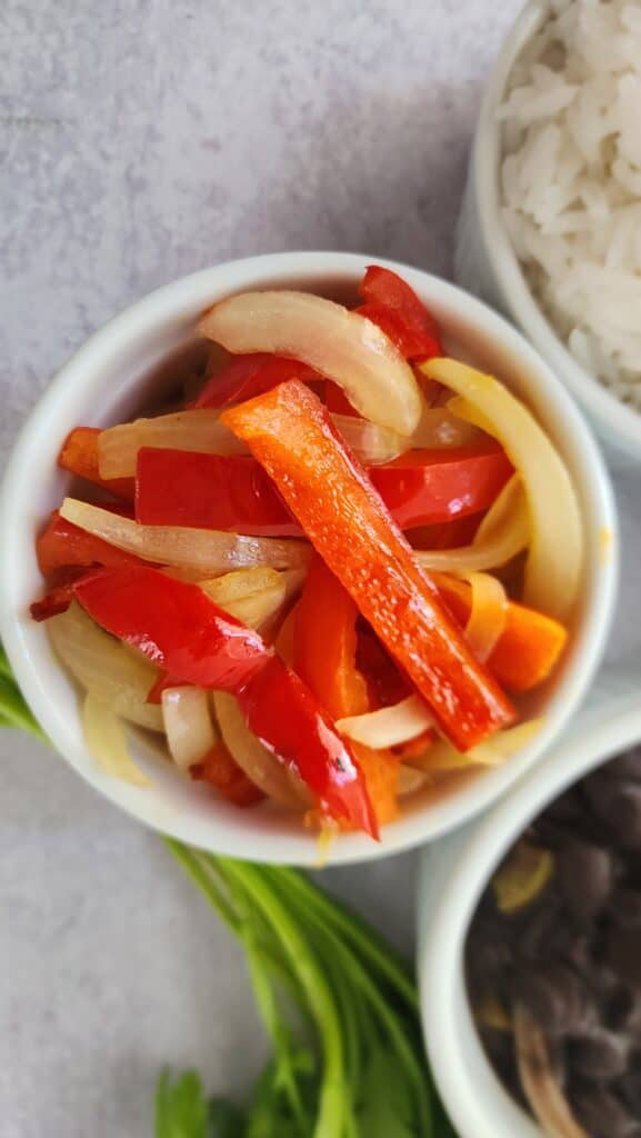 sauteed peppers and onions in a ramekin for Chipotle Burrito Bowls