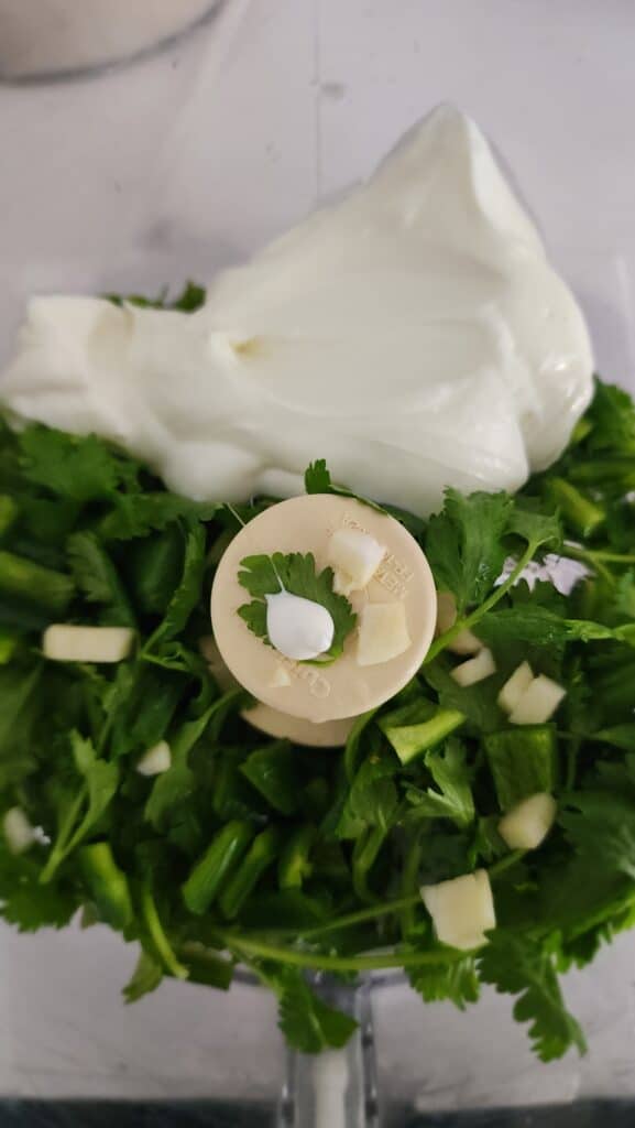 all the ingredients for cilantro jalapeño sauce in the food processor before blending