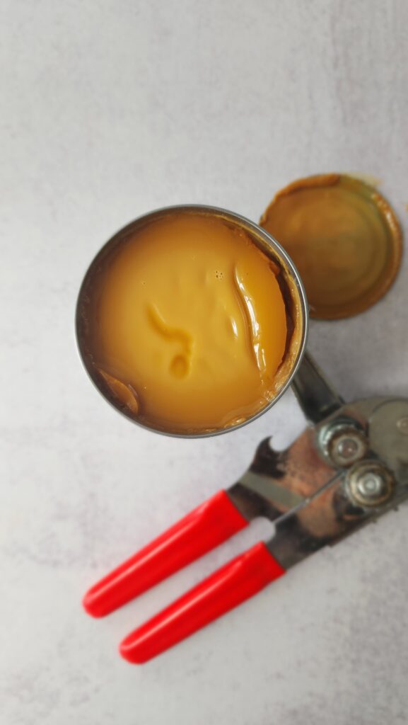 opened can of sweetened condensed milk that is now been cooked to be dulce de leche