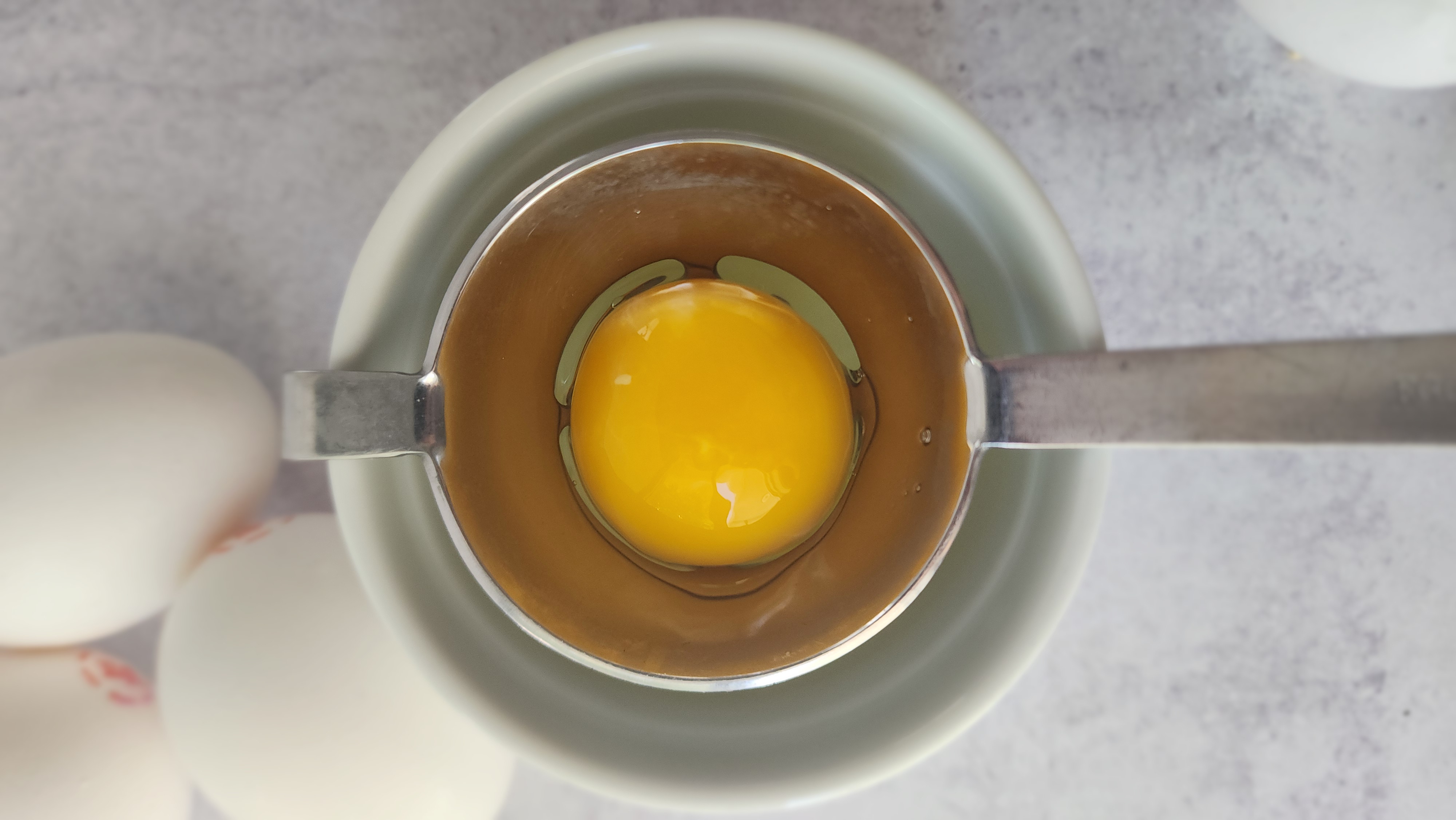 eggs being separated just for the egg whites to make strawberry pavlova