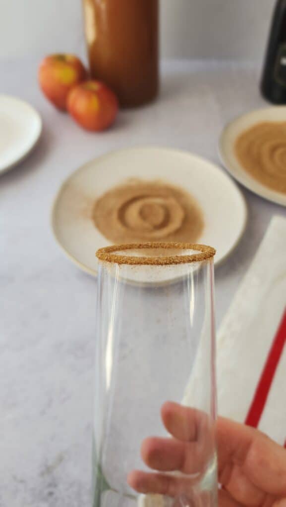 glass rimmed with cinnamon sugar for apple cider mimosas