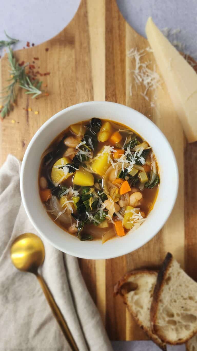 final top shot of a bowl of Easy Ribollita Soup with a slice of toasted bread ready for dunking