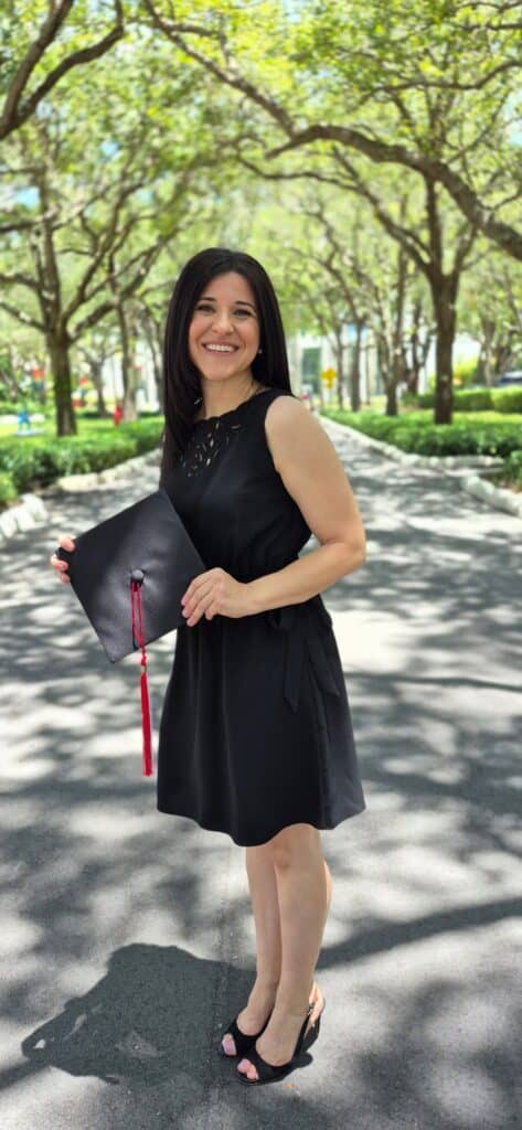 picture of myself holding my cap for my master's graduation