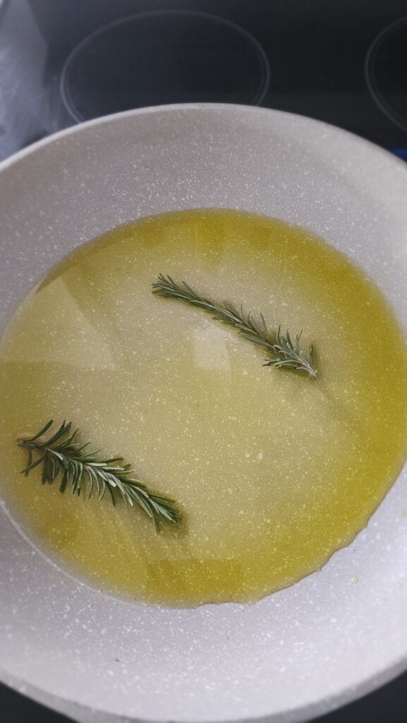 pan of olive oil and rosemary for rosemary Marcona almonds