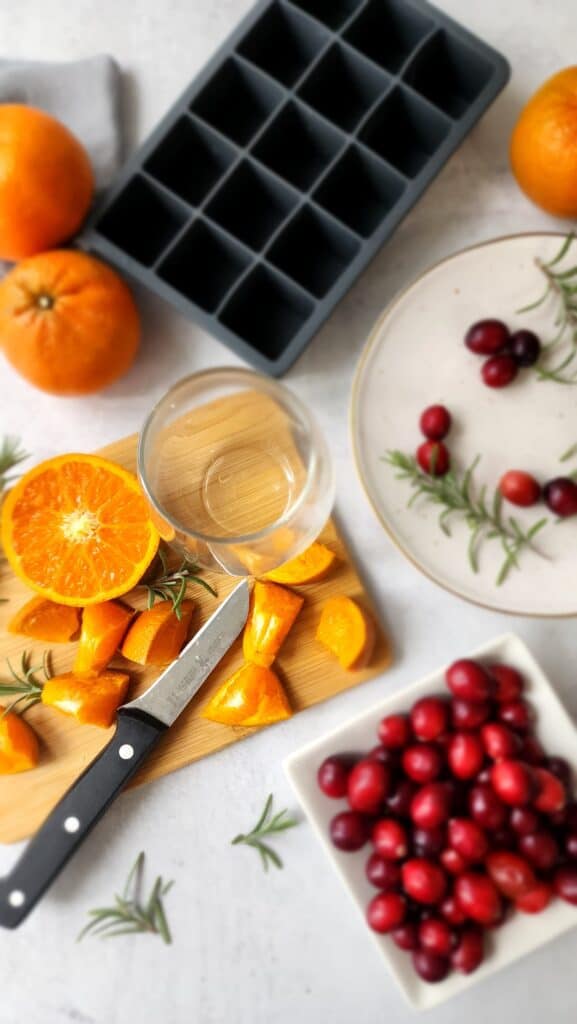 orange, cranberries, rosemary to make homemade ice cubes