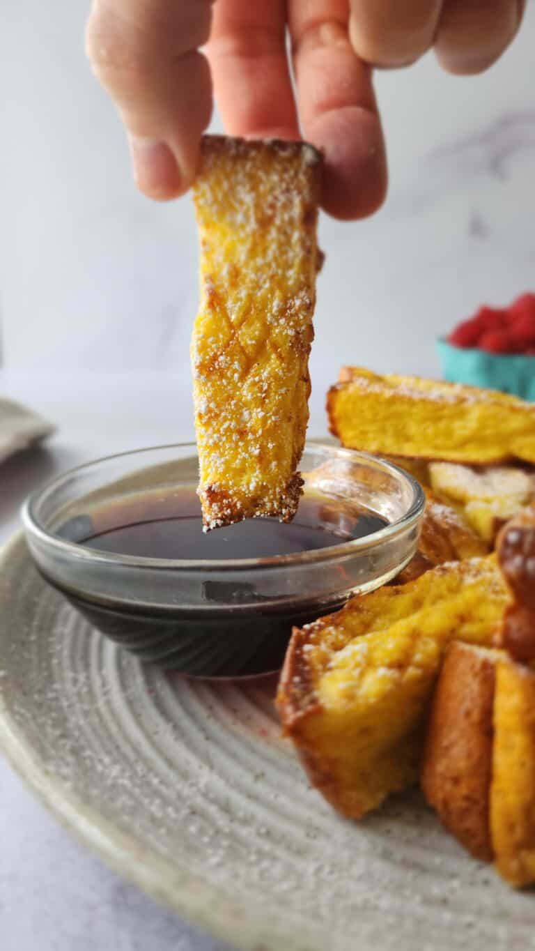 one single French Toast stick dipped in maple syrup