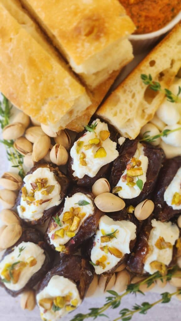 up close picture of goat cheese stuffed dates with thyme & pistachios