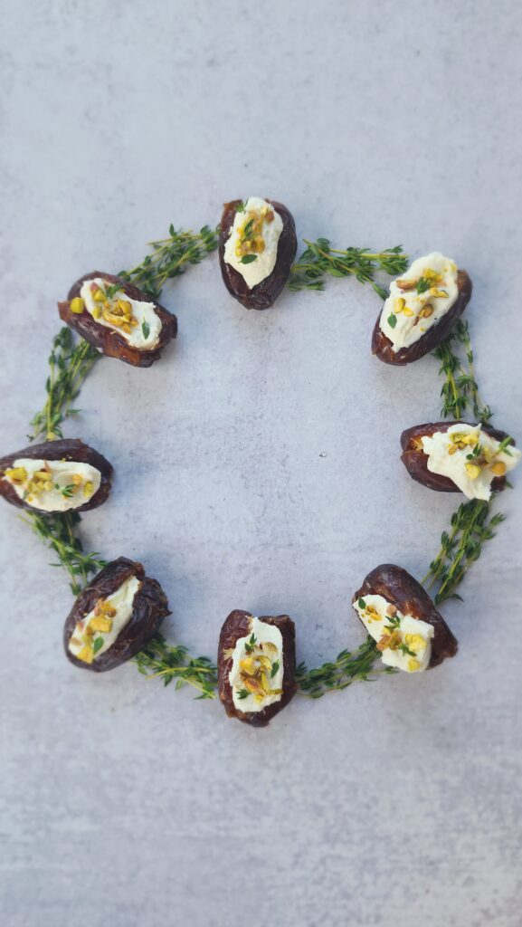 wreath with goat cheese stuffed dates with thyme & pistachios