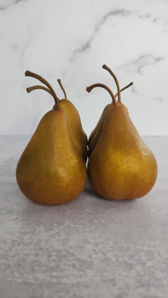 bosc pears before peeling for Red Wine Poached Pears