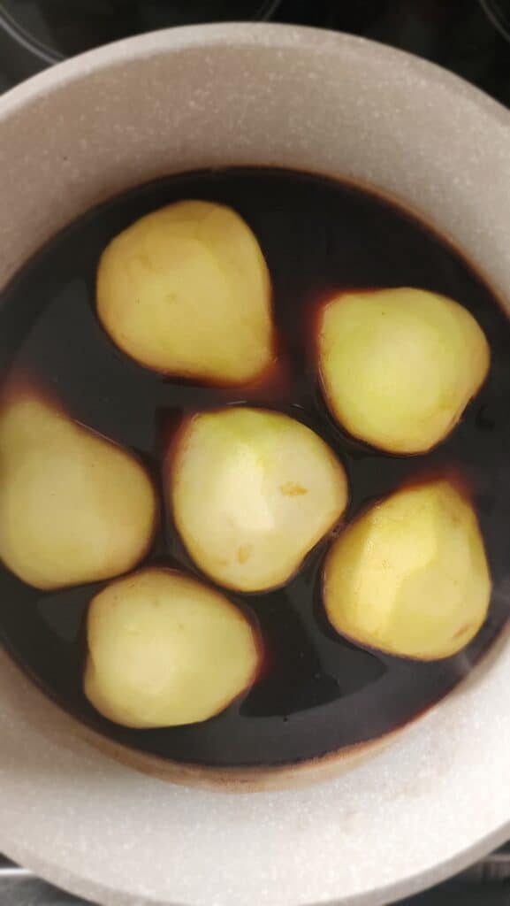 pears simmering in the red wine for Red Wine Poached Pears