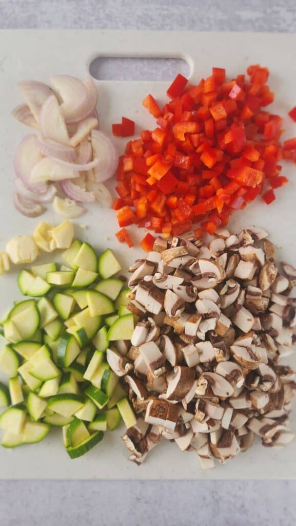 all the veggies for skillet lasagna cut: onion, red pepper, zucchini, mushrooms