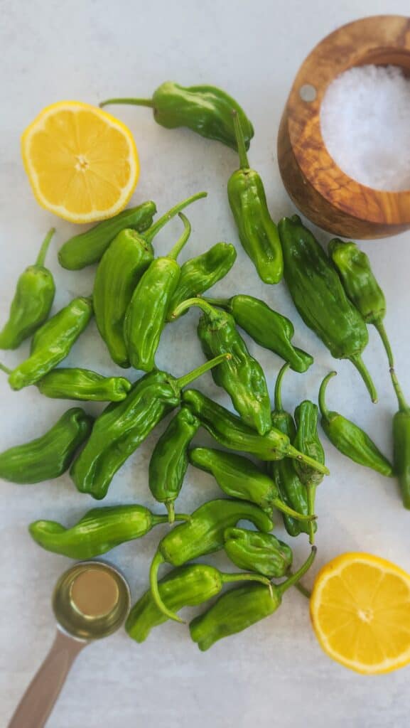ingredients to make grilled shishito peppers: shishito peppers, olive oil, salt, lemon