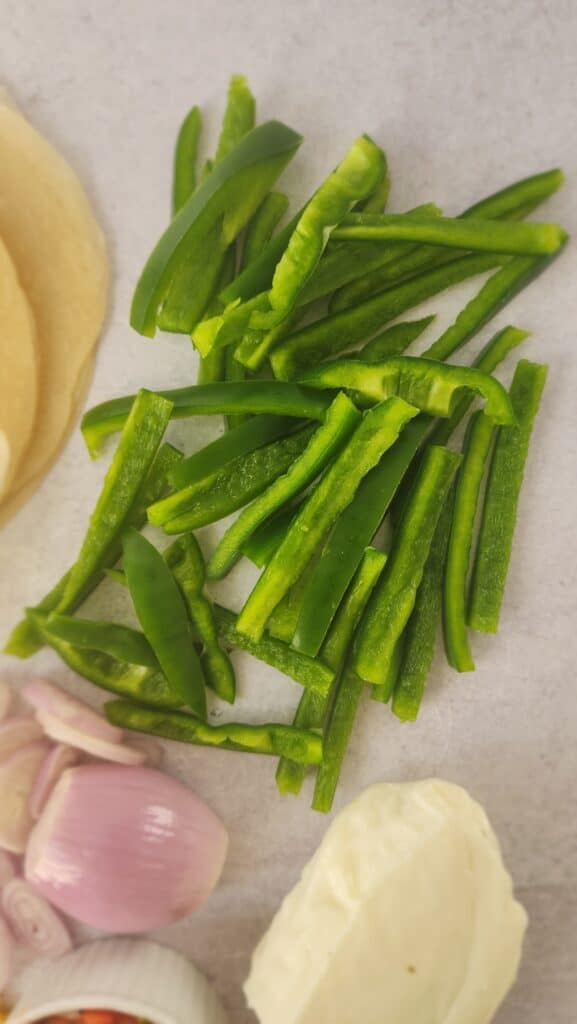 green pepper slices ready to sauté for Halloumi Tacos