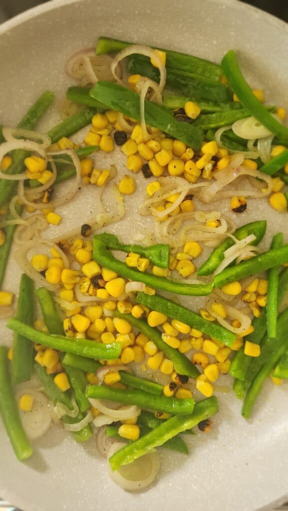 sautéing green pepper, shallots, and charred corn for halloumi tacos
