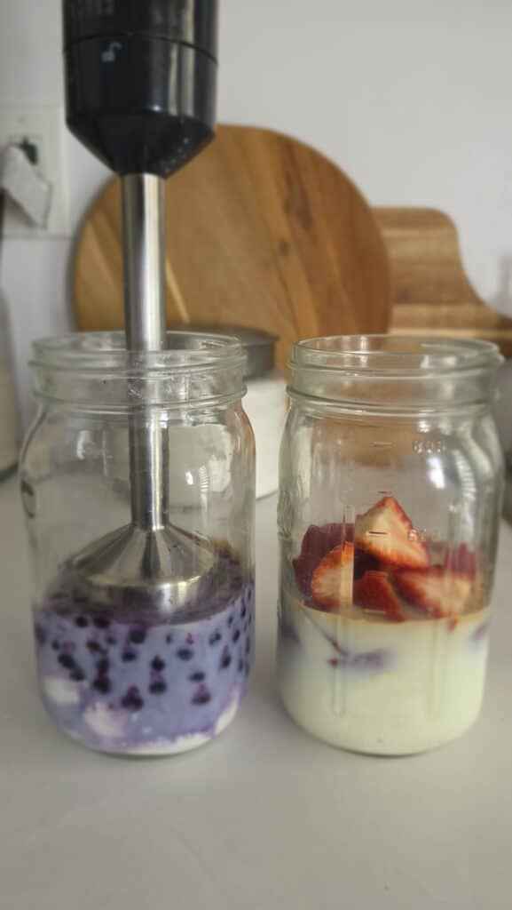 ingredients in a mason jar about to be blended with an immersion blender for a Copycat Chobani Yogurt Drink