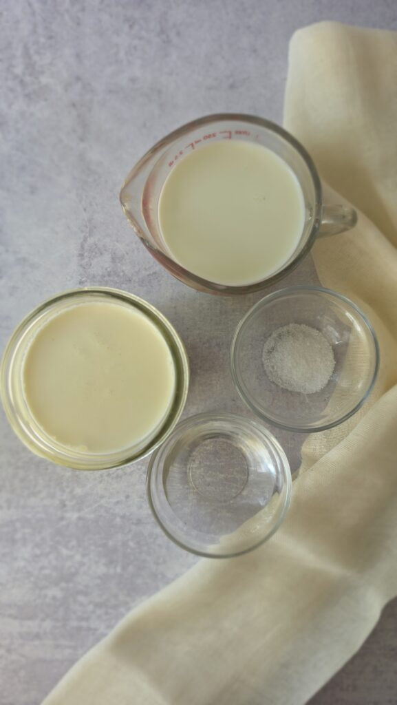 ingredients for homemade ricotta: heavy whipping cream, whole milk, salt, white wine vinegar