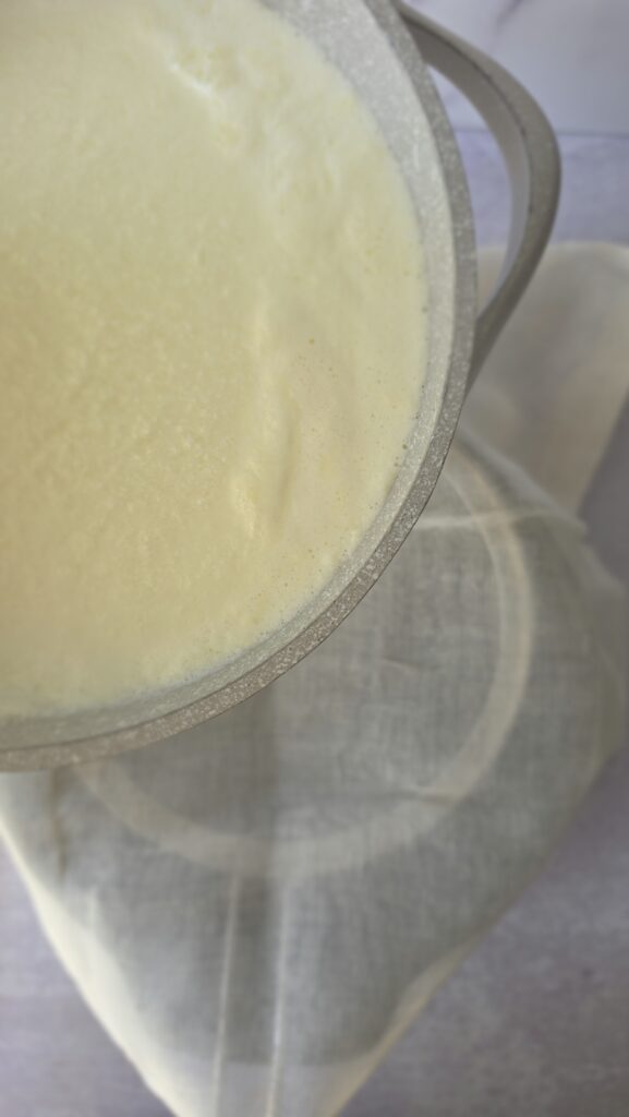 pouring the ricotta mixture to strain and make homemade ricotta