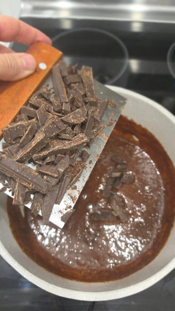 adding in the dark chocolate for hot fudge sauce