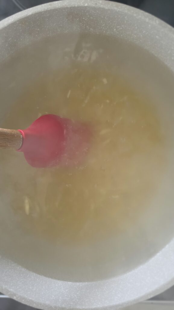 orzo submerged in boiling water cooking for orzo salad