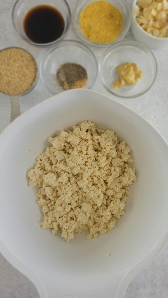 crumbled tofu in a bowl for glazed tofu loaf