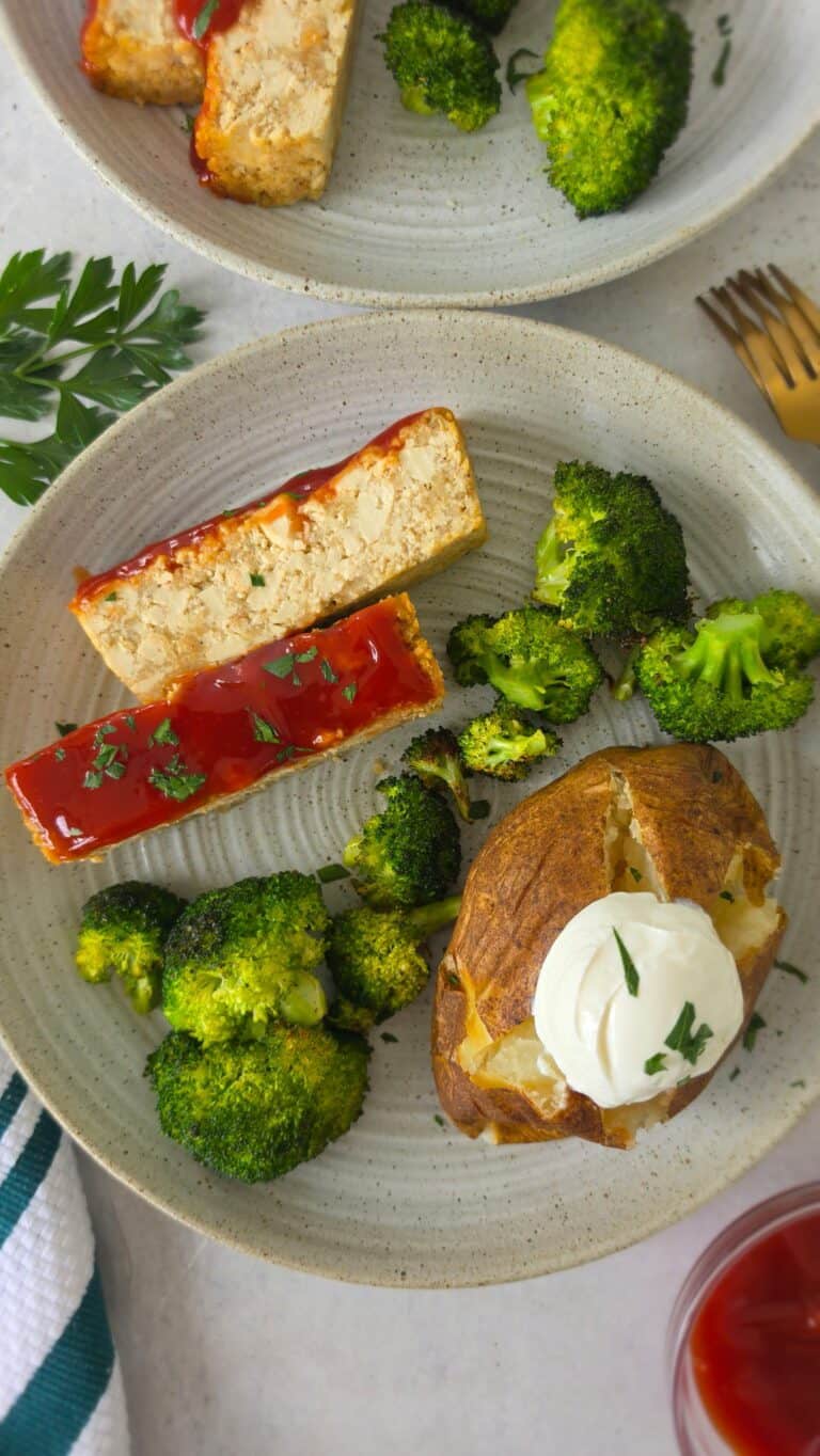 plated glazed tofu loaf with a baked potato and roasted broccoli