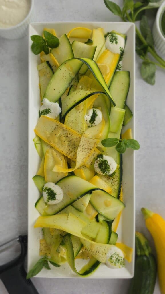 plated summer squash ribbon salad with homemade ricotta and basil oil