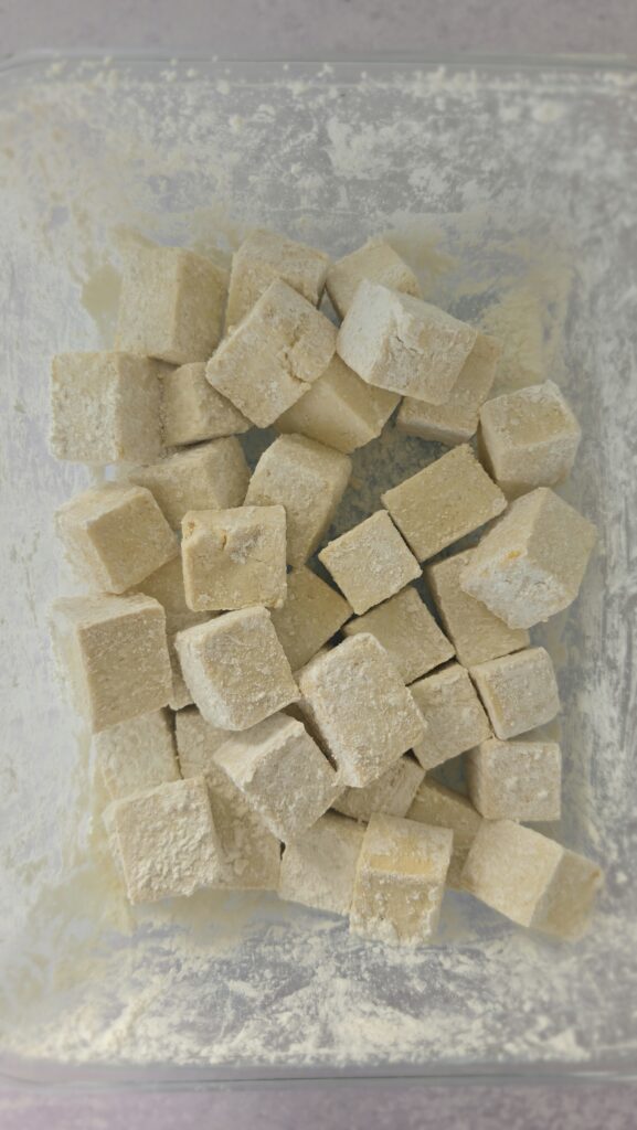 the cornstarch evenly coated over the tofu cubes