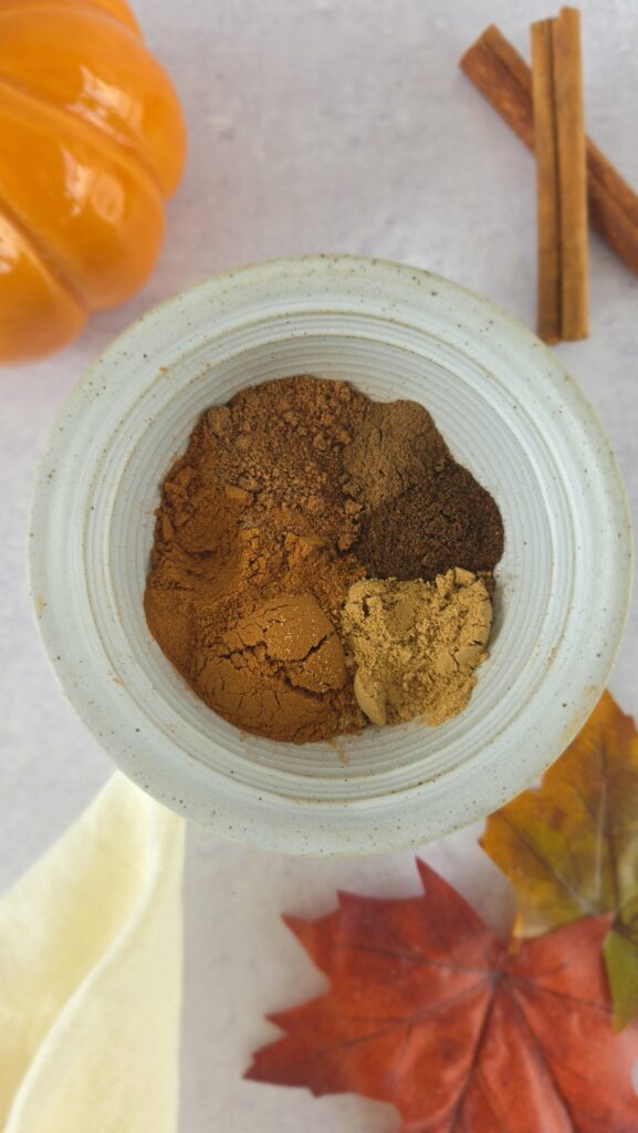 all the spices for homemade pumpkin pie spice in a bowl before mixing