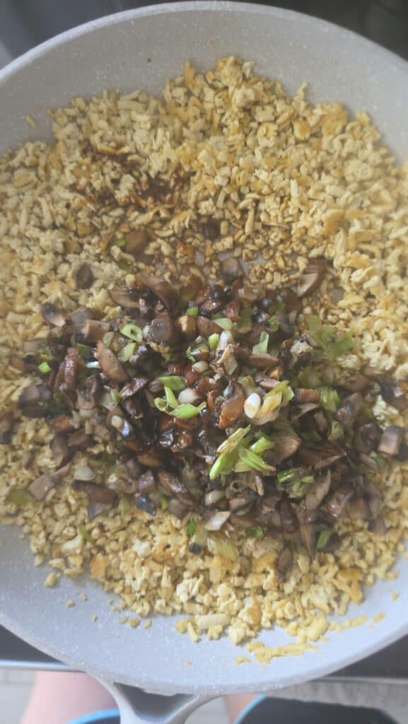 combining the cooked mushrooms and scallions with cooked tofu for easy lettuce wraps with mushrooms