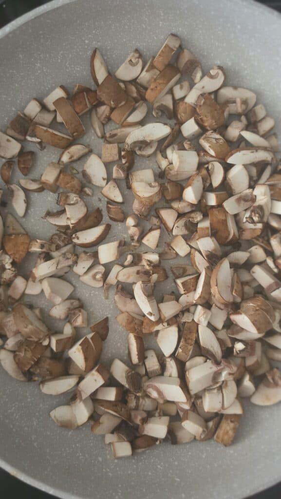 diced mushrooms cooking in a sauté pan for easy tofu lettuce wraps with mushrooms