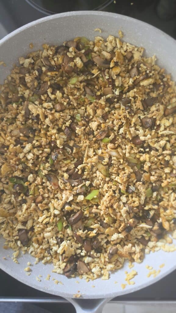 adding the hoisin sauce, soy sauce, and rice wine vinegar to the cooked tofu and mushrooms for easy tofu lettuce wraps with mushrooms