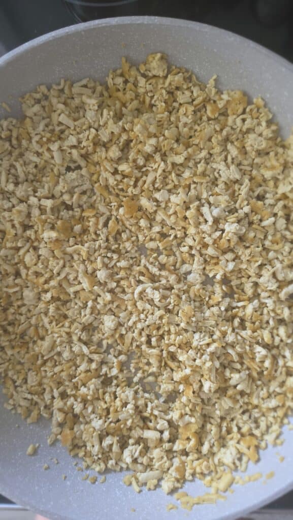grated tofu cooking in a sauté pan for easy tofu lettuce wraps with mushrooms