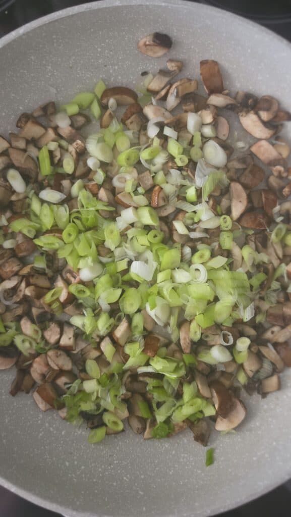 mushrooms and scallions cooking in a sauté pan for easy lettuce wraps with mushrooms