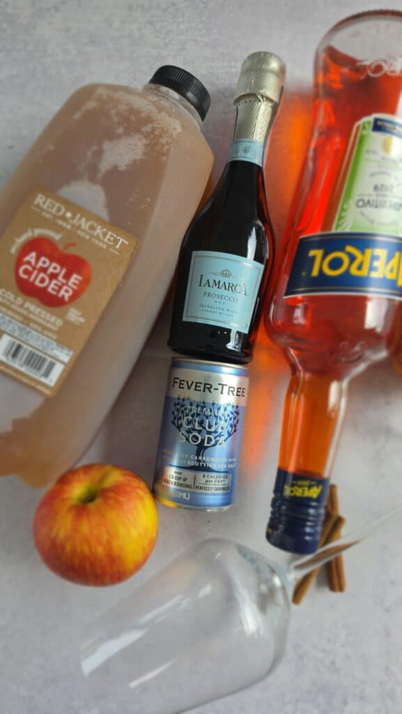 ingredients for an Apple Cider Aperol Spritz: apple cider, Aperol, Prosecco, Club Soda