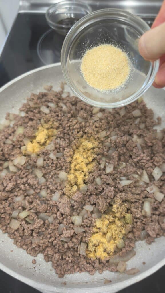 ground beef adding spices for burger bowls