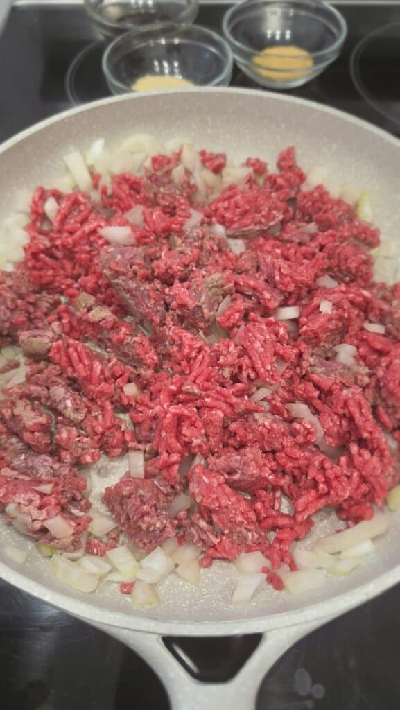 sautéing ground beef with onions for burger bowl