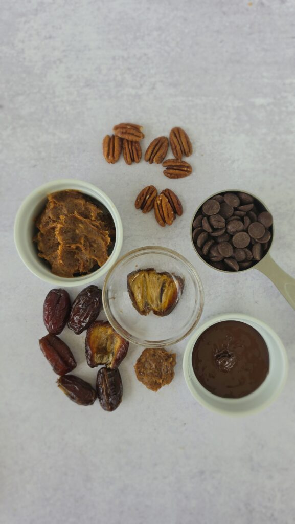 ingredients for date caramel turtles: dates, pecans, dark chocolate chips