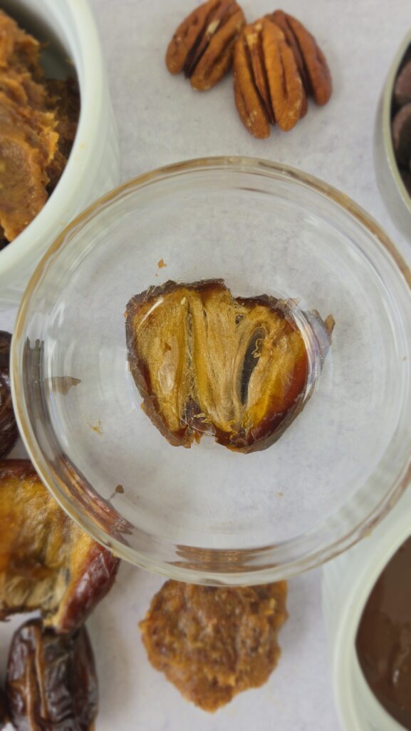 placing a bowl to flatten the medjool dates for the Date Caramel Turtles