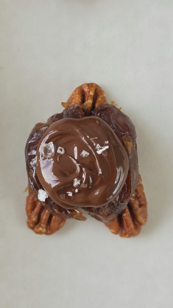 whole date with pecans and then chocolate dolloped on top