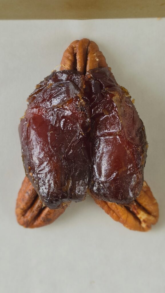 Flipping the whole date over with the pecans sticking out to look like a turtle