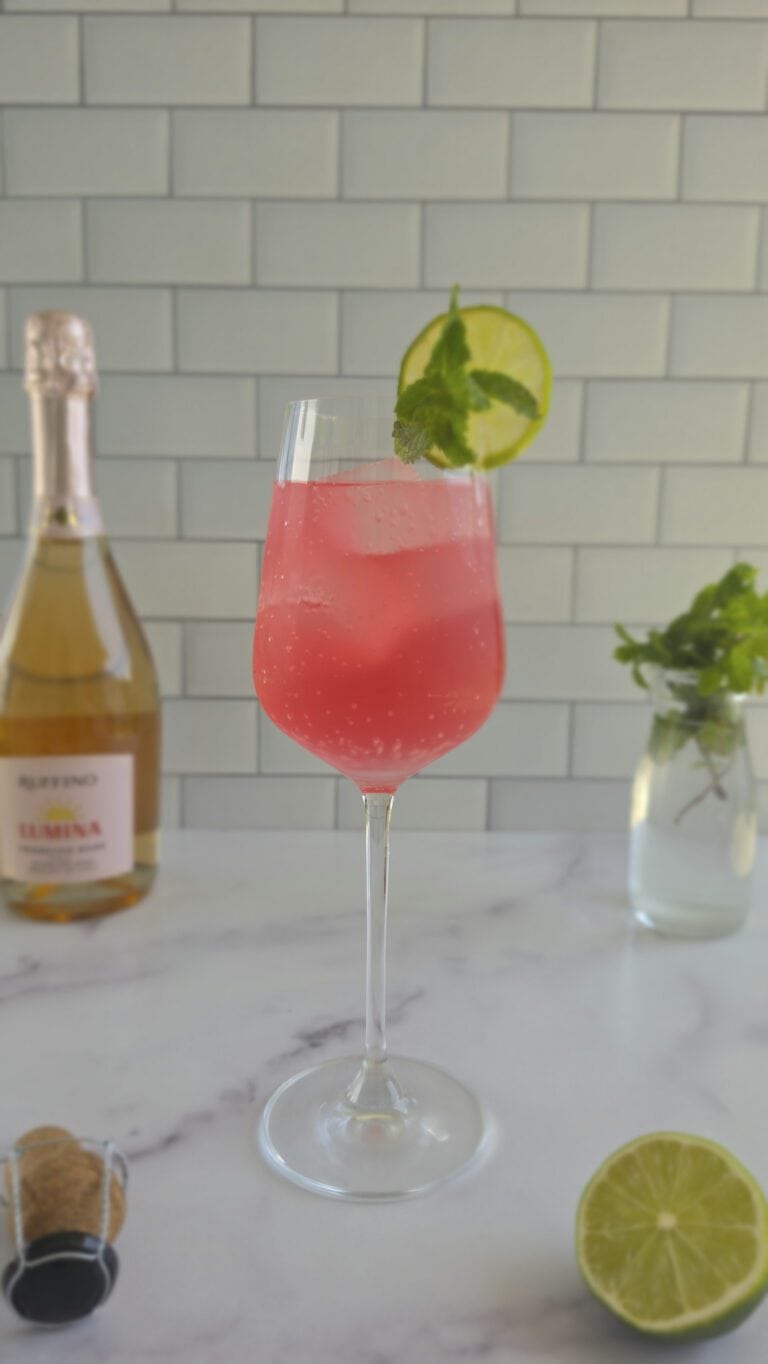 picture of Rosa Sarti Spritz with a lime wheel and sprig of mint